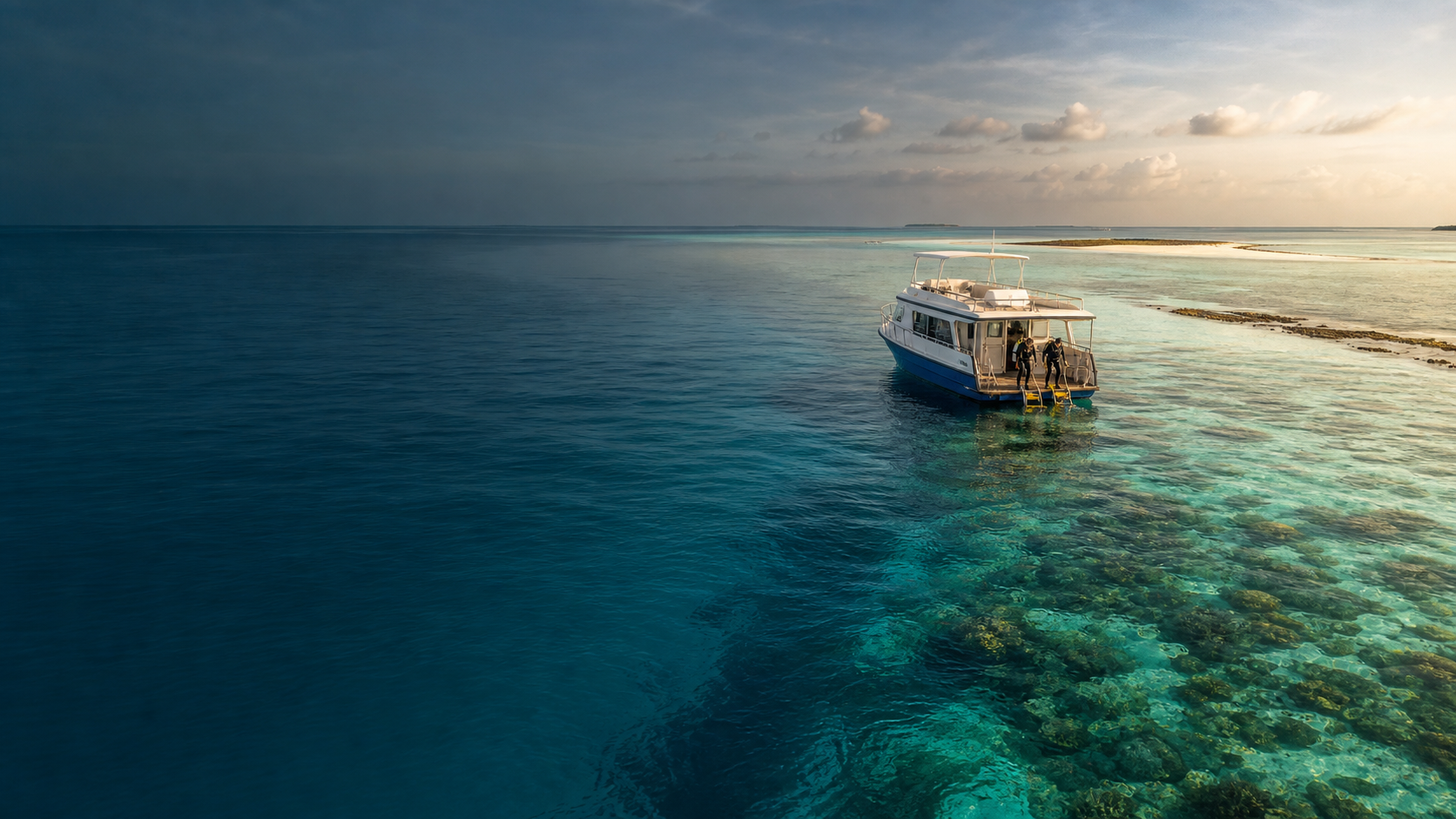 Divers stepping off a dive boat at sunrise