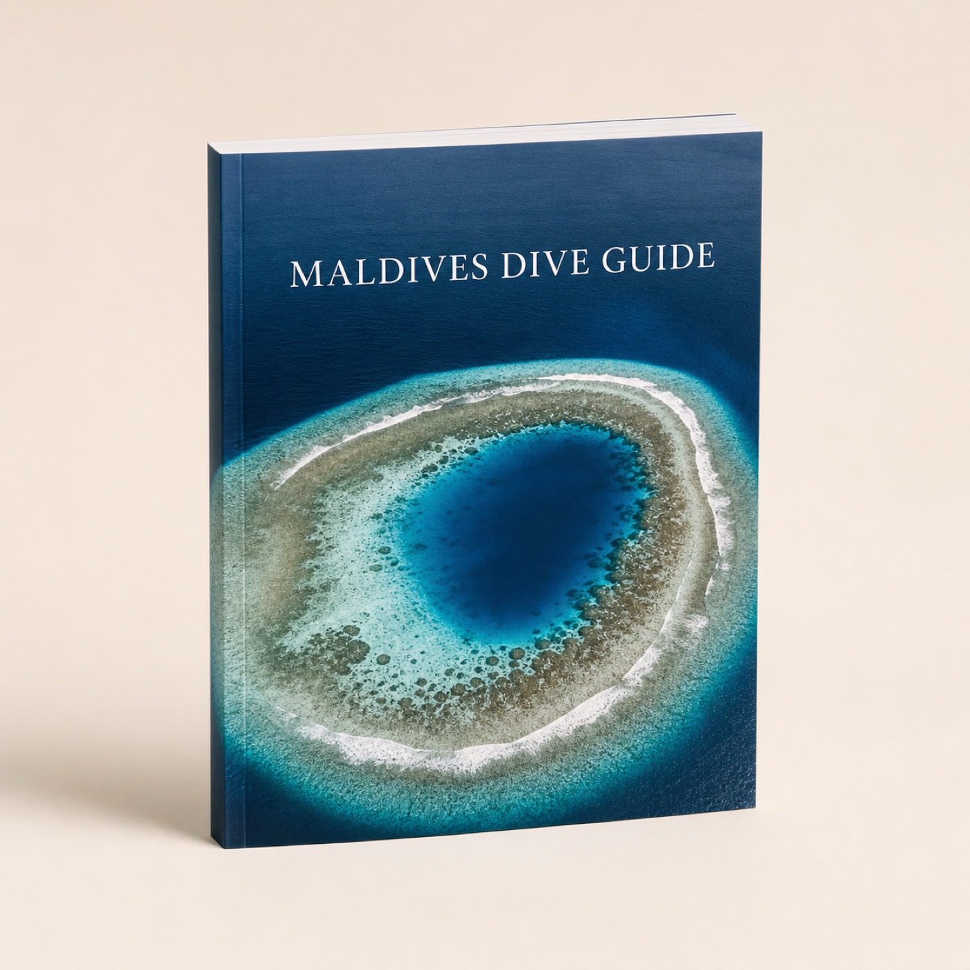 Maldives Dive Guide book with an aerial island photograph on its cover